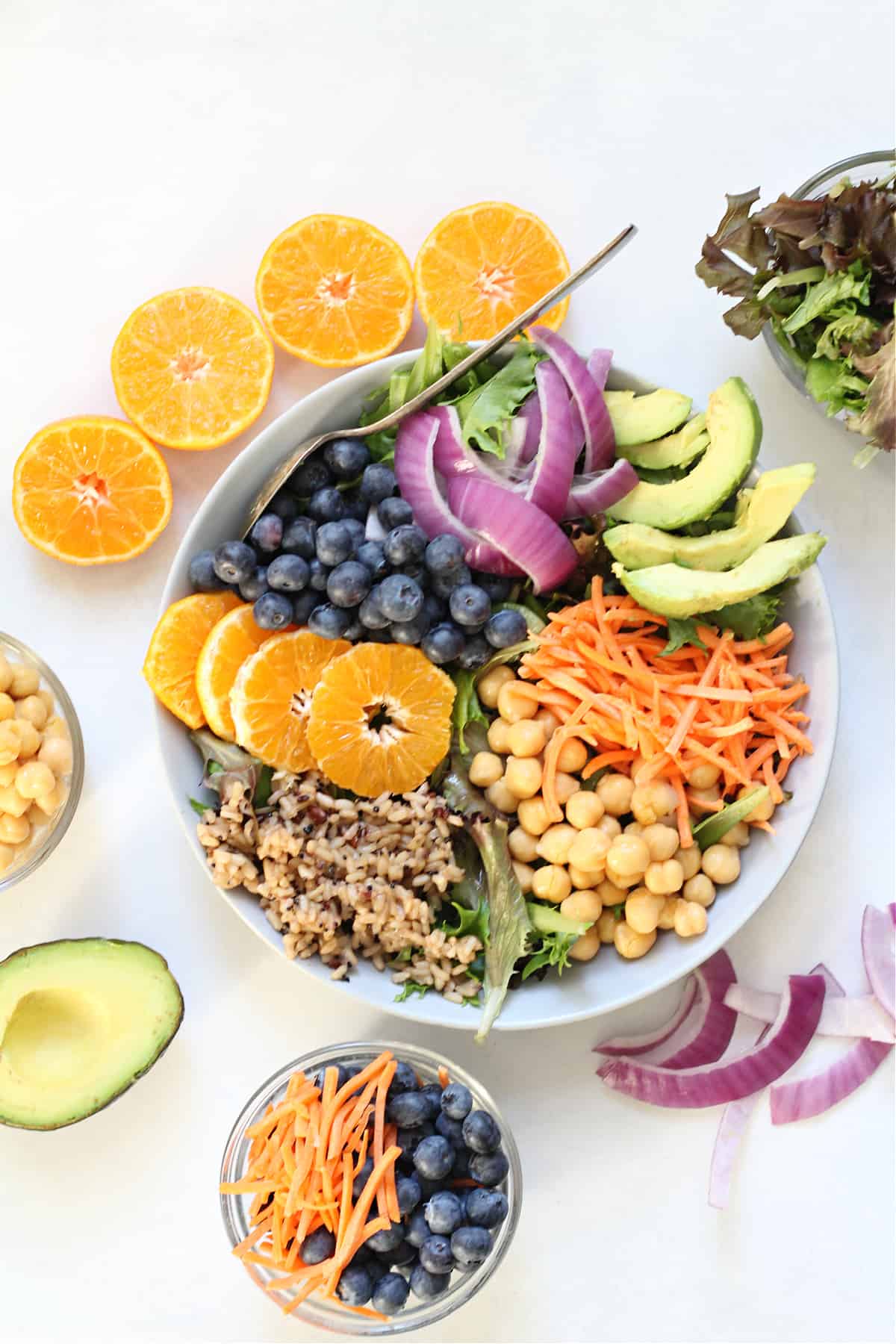 A vibrant bowl filled with grains, greens, and a creamy dressing. Perfect for mixing and matching your favorite ingredients.