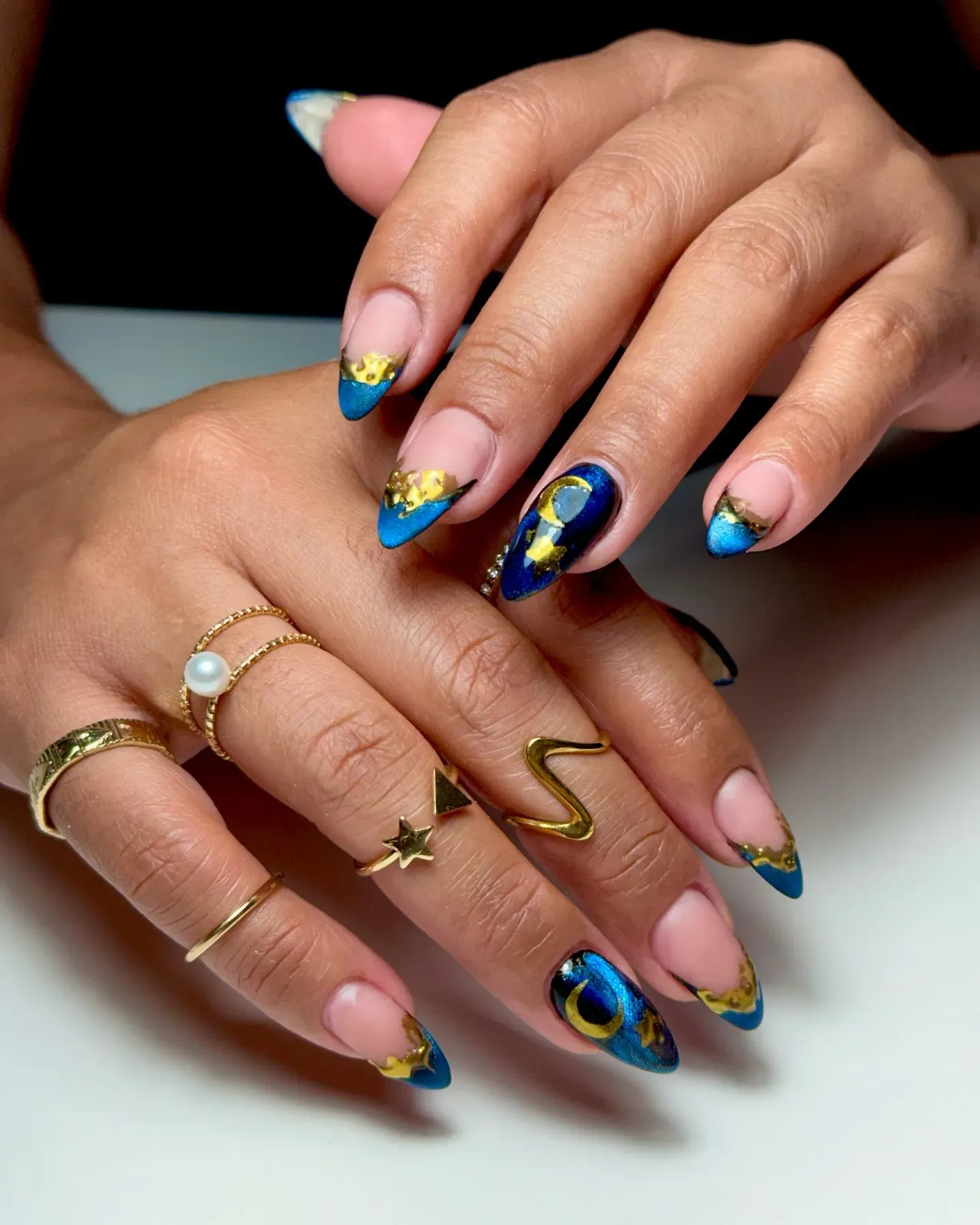 Blue and gold French tips meet moon and star detailing for a magical twist on classic glam. Perfect for earthy nail designs that still sparkle like the night sky. ๐๐