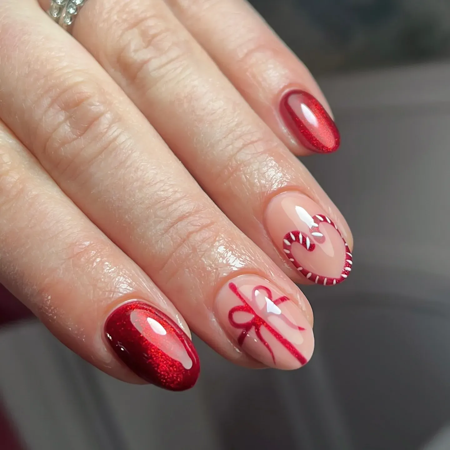 Glossy red meets candy-cane hearts and ribbon accents for the sweetest red Christmas nails ever. Perfect if you love cute holiday nails that still look classy enough for any Christmas party. โค๏ธ๐ฌ๐