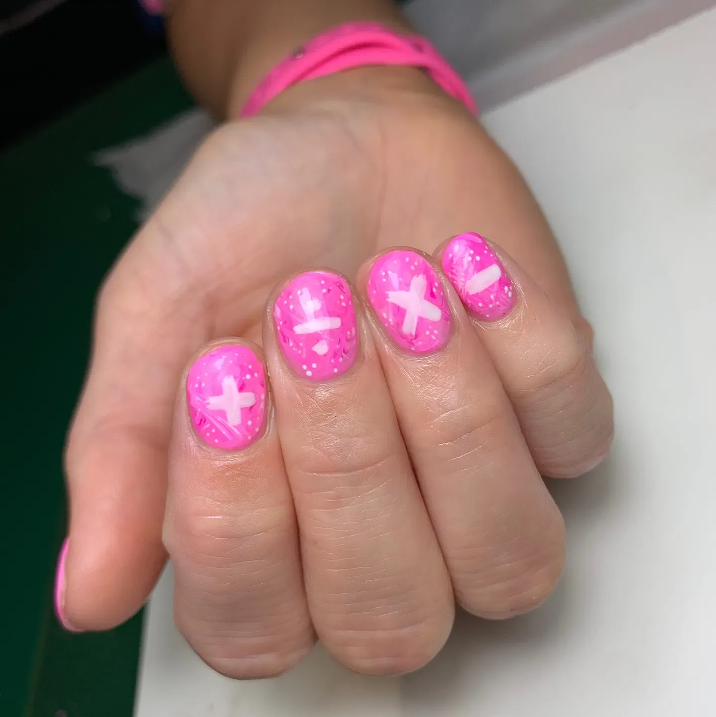 These hot pink nails are full of personality with their mix of marble swirls, white X accents, and speckled dots. A perfect choice if you love bright pink summer nails that stand out and still feel totally wearable.