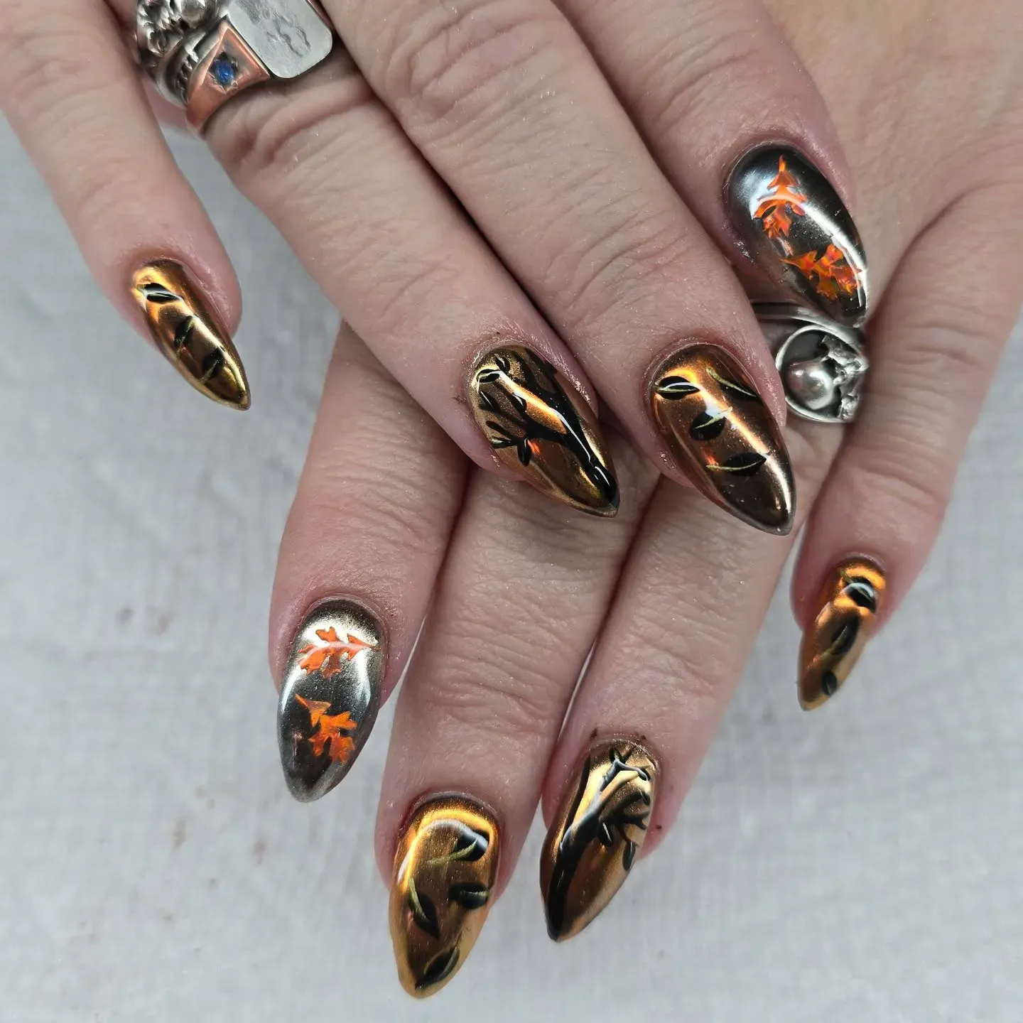 Burnished gold chrome with leafy designs in copper and orange — this look is the ultimate fall statement set.