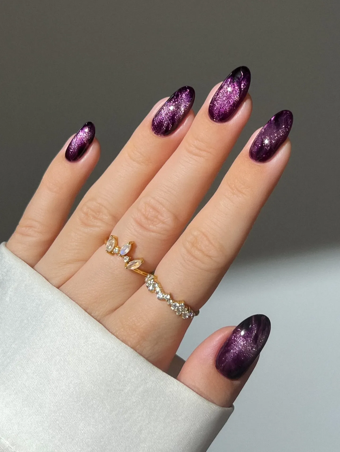 Love a little sparkle? These plum purple nails combine glossy polish with glitter accents and subtle marble swirls for an elegant fall statement manicure.