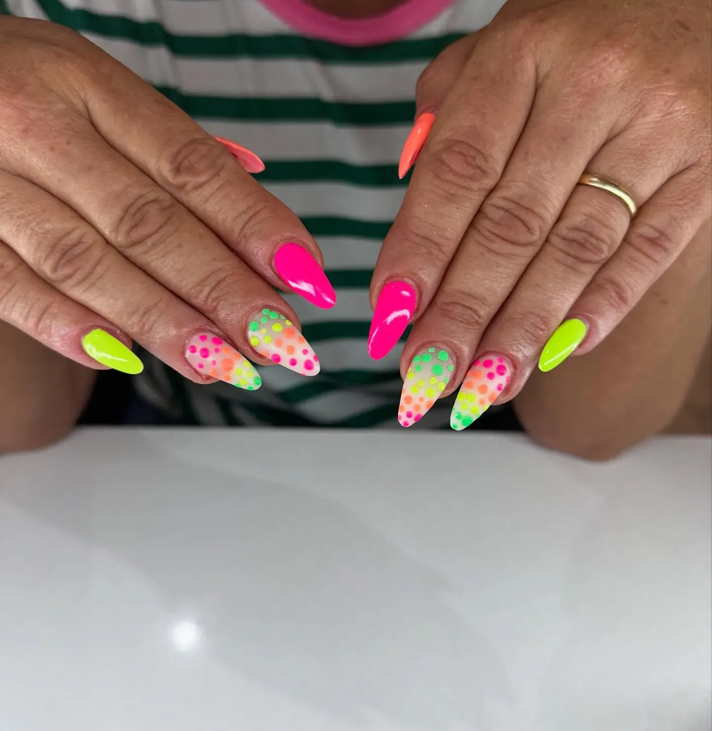 If you can’t choose just one color — don’t! These dotted tips blend lime green, hot pink, and orange in the most playful way possible.