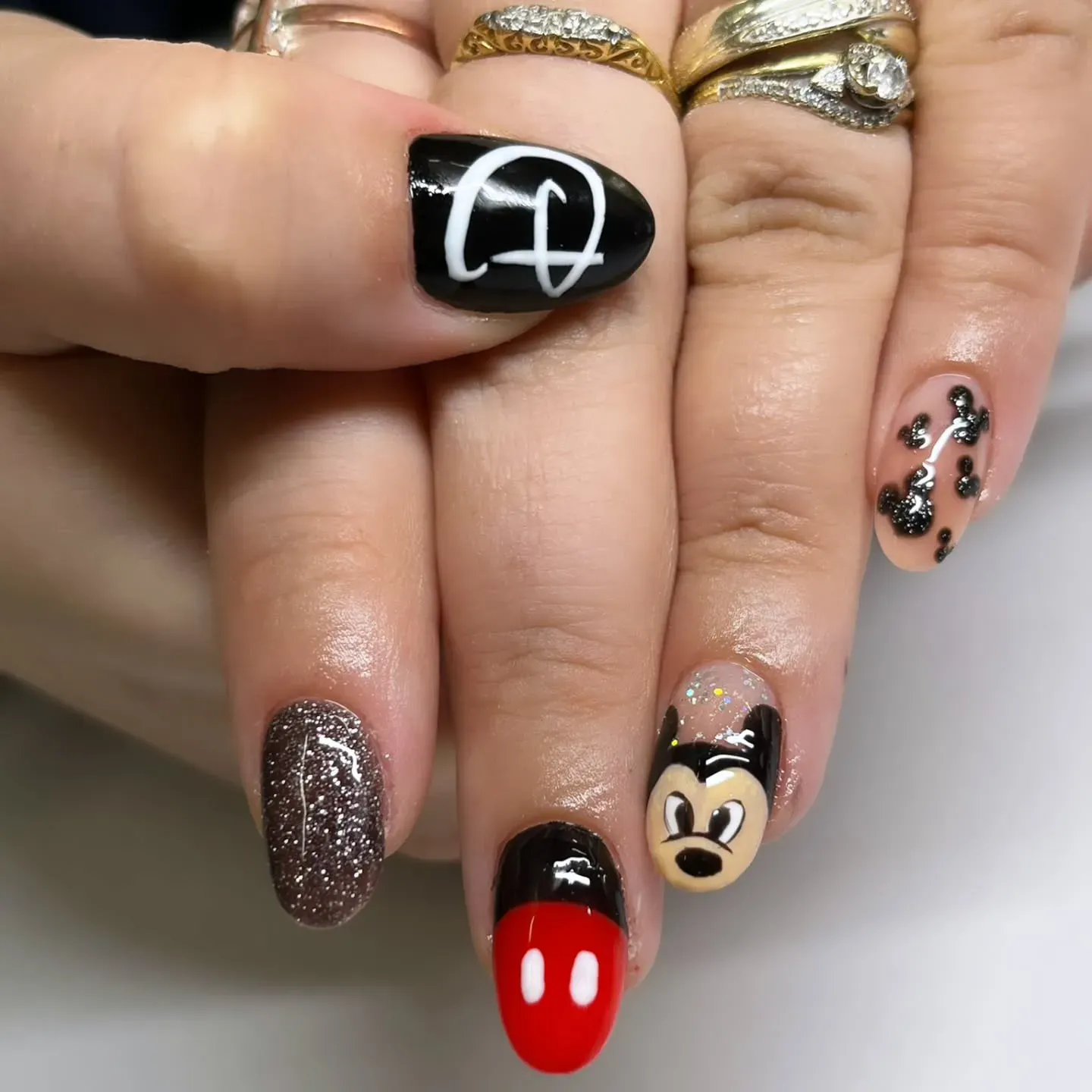 A glitzy take on the theme with silver sparkles, glossy black polish, and a minimalist Mickey — perfect for a night at Disney Springs.