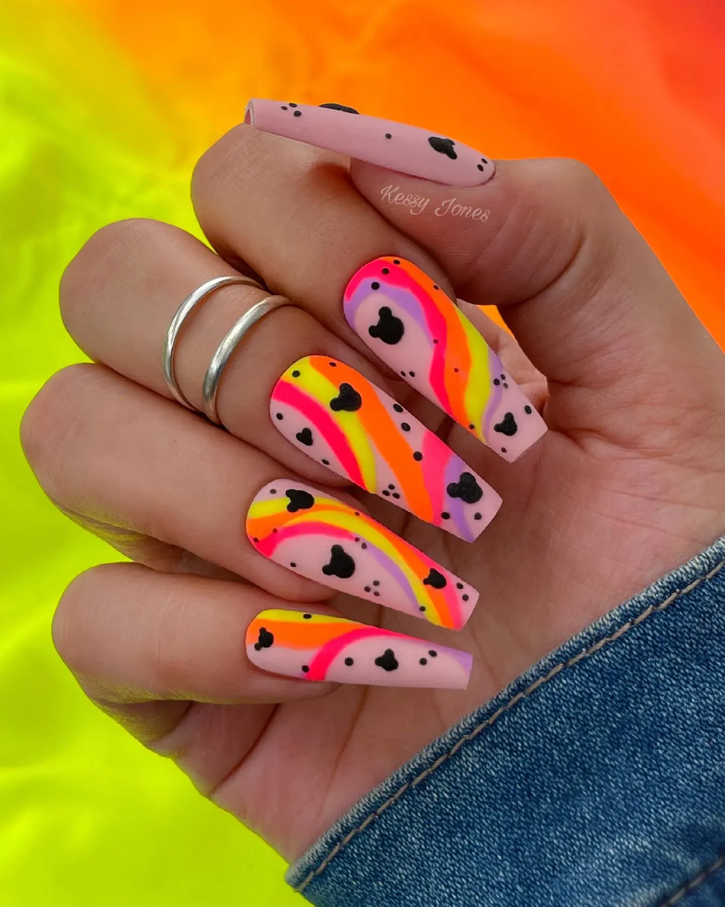 A playful mix of hot pink, orange, and yellow swirls with tiny Mickey silhouettes — bright, fun, and perfect for sunshine-filled park days!