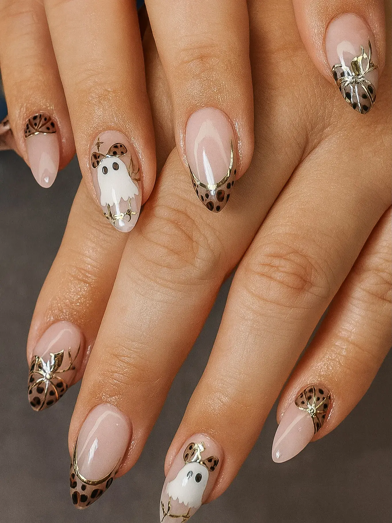 A playful twist on animal print! These cheetah and gold nails feature metallic French tips, butterflies, and even a tiny ghost design. Cute, quirky, and perfect for seasonal cheetah print nail art.