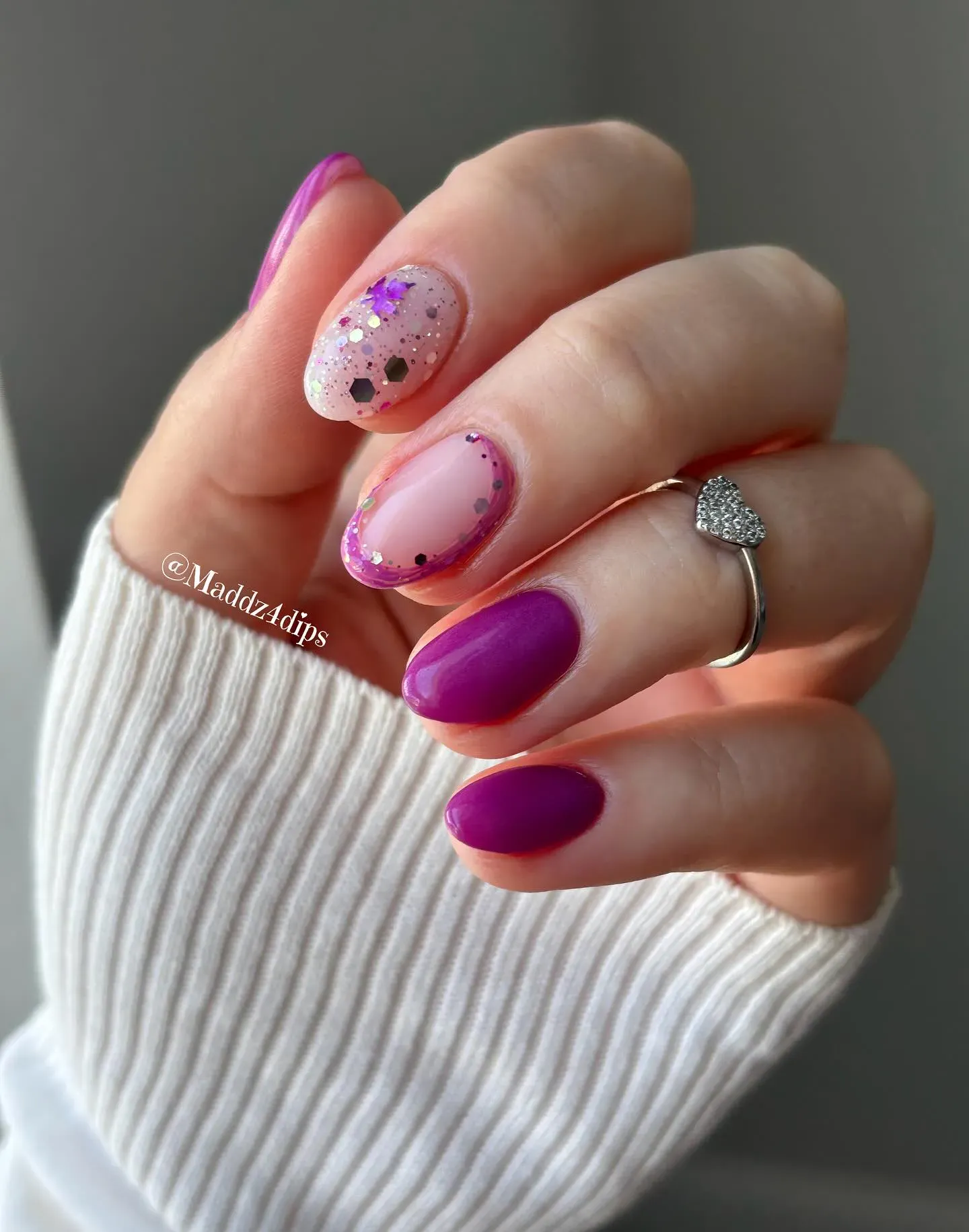 These simple purple nail designs are effortlessly pretty — a balance of sheer glitter, purple French tips, and glossy plum accents. They’re easy to wear and full of fall charm.