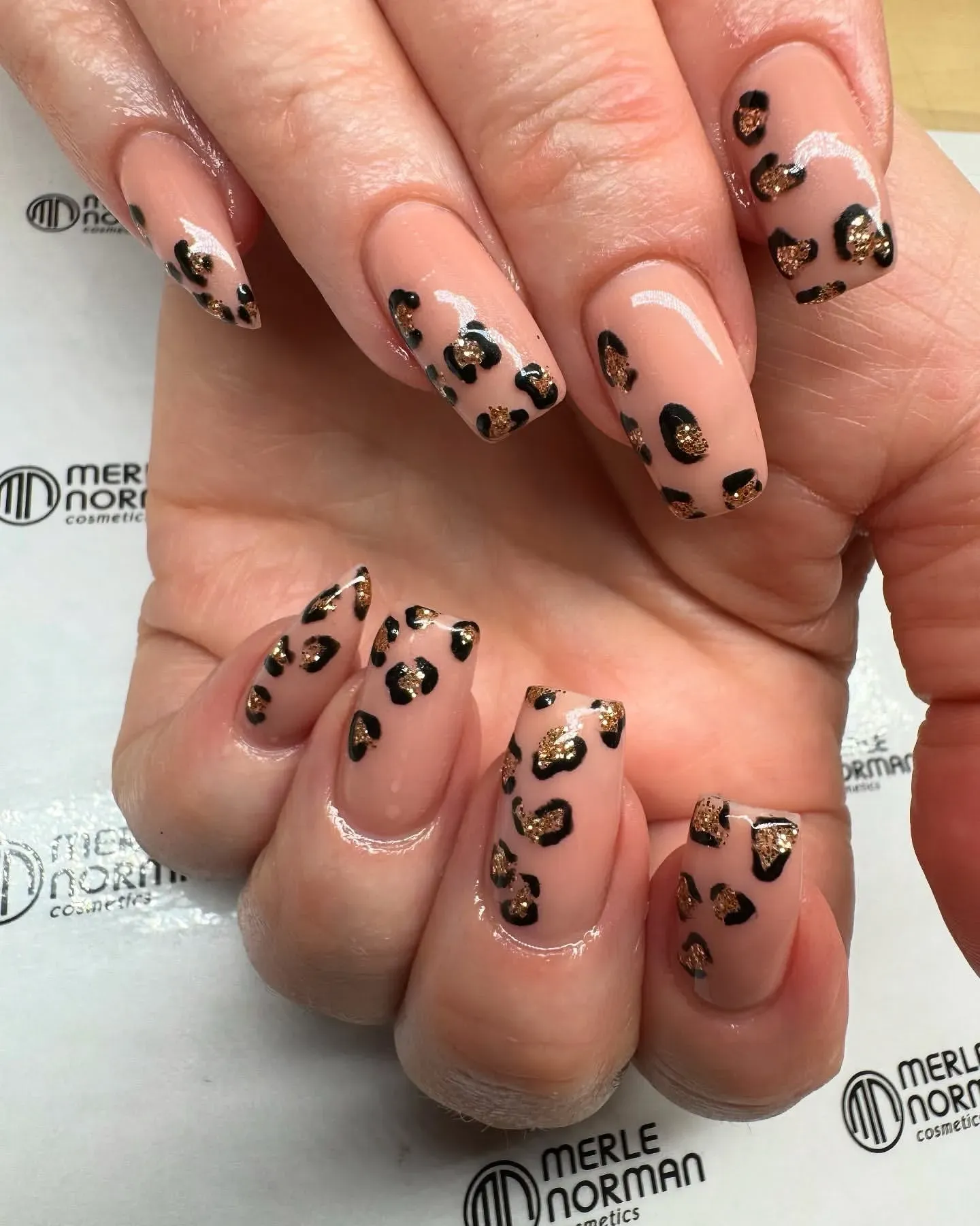 You can’t go wrong with brown cheetah print nails on a nude base. This classic version adds tiny metallic touches for subtle sparkle — perfect for everyday wear or a polished office look.