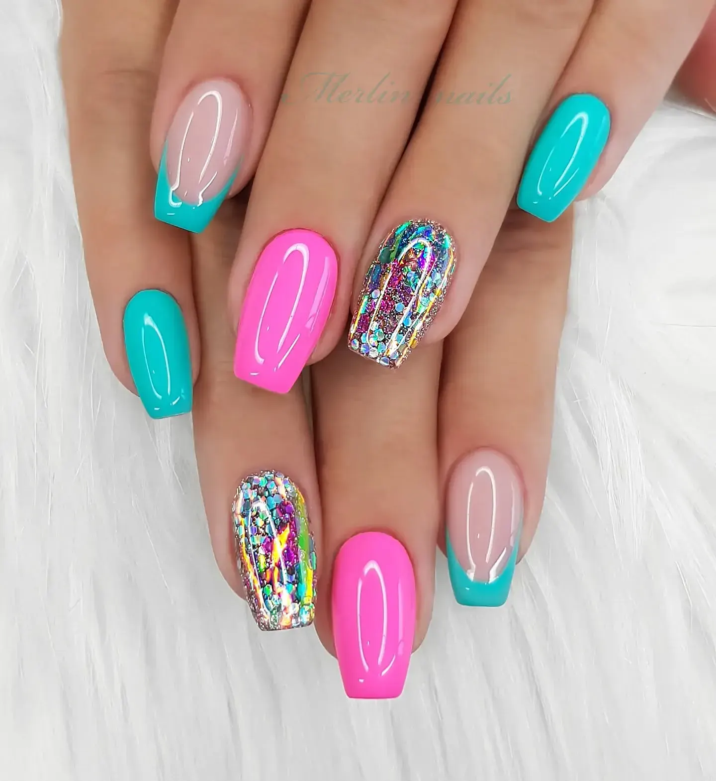 Bright turquoise, bubblegum pink, and glitter accent nails make this look pop — like summer bottled up on your fingertips.