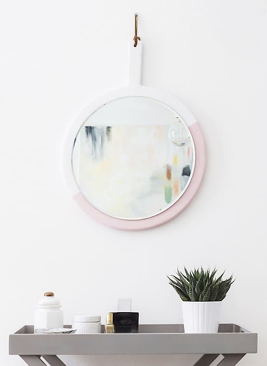 Use a chopping board to make a hanging mirror