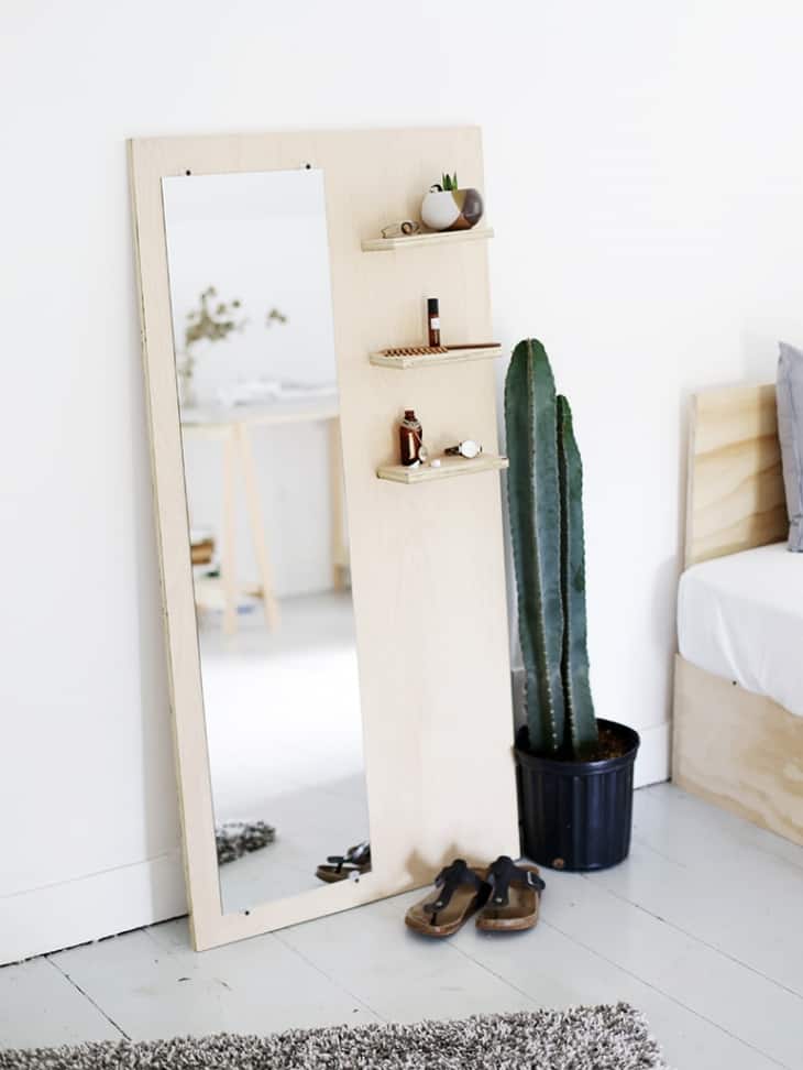 Add some storage space to a standing mirror