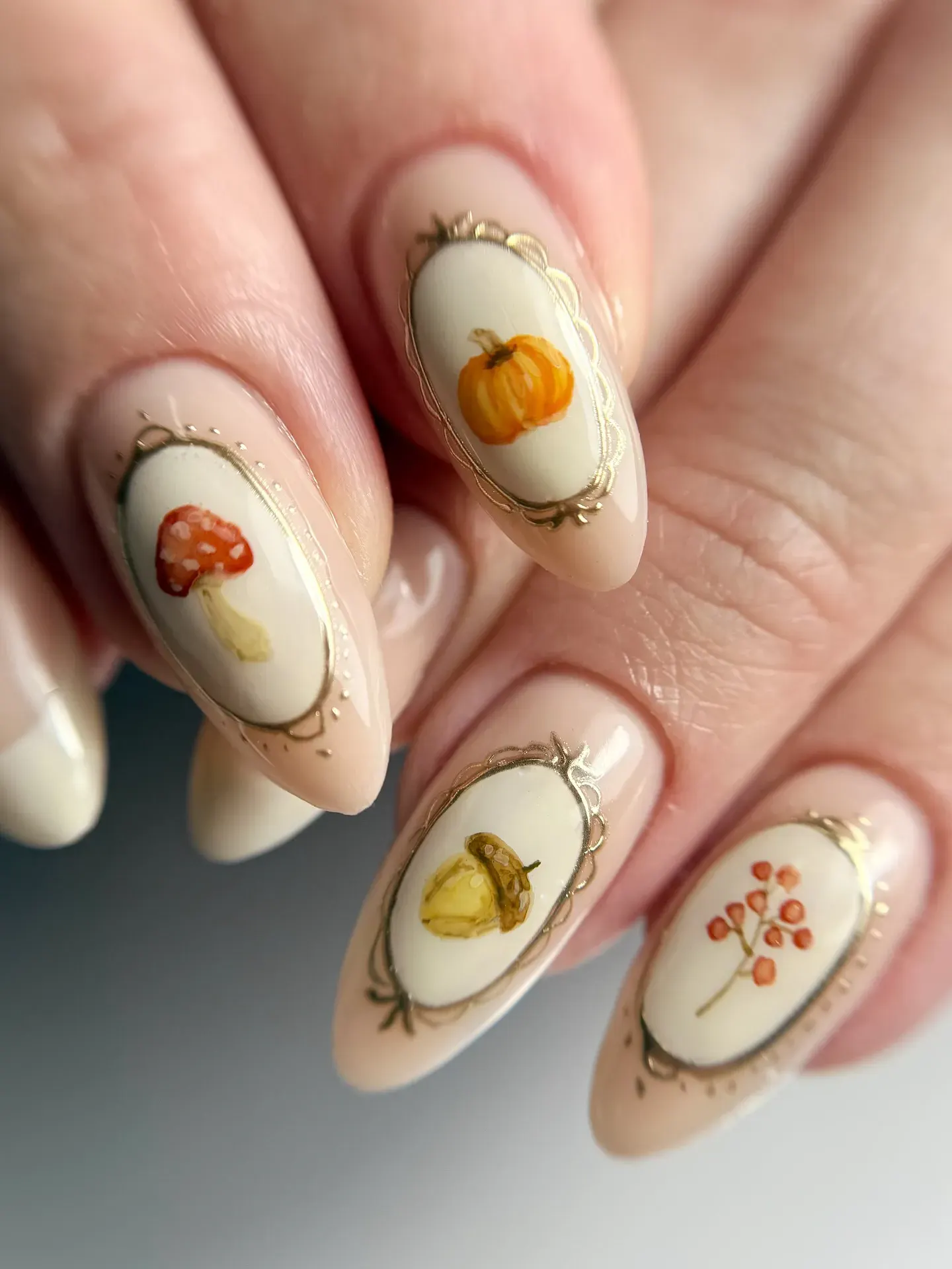 Hand-painted fall motifs like pumpkins, acorns, and berries framed with gold chrome — a masterpiece for your fingertips.