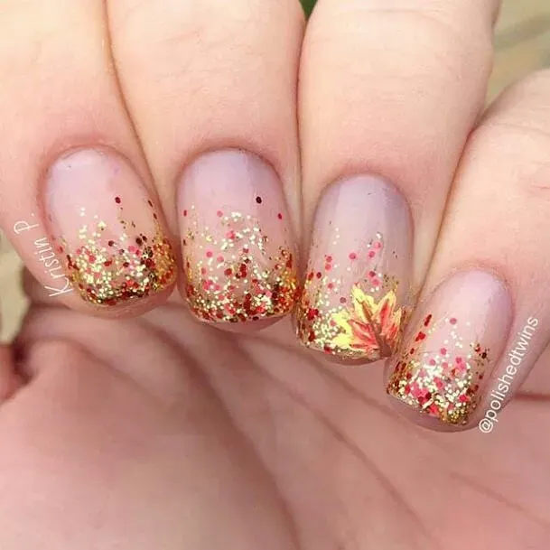 Gold glitter tips with a tiny autumn leaf detail bring all the cozy vibes. These sparkly nails are a fun way to wear fall nail colors while keeping things soft and seasonal.