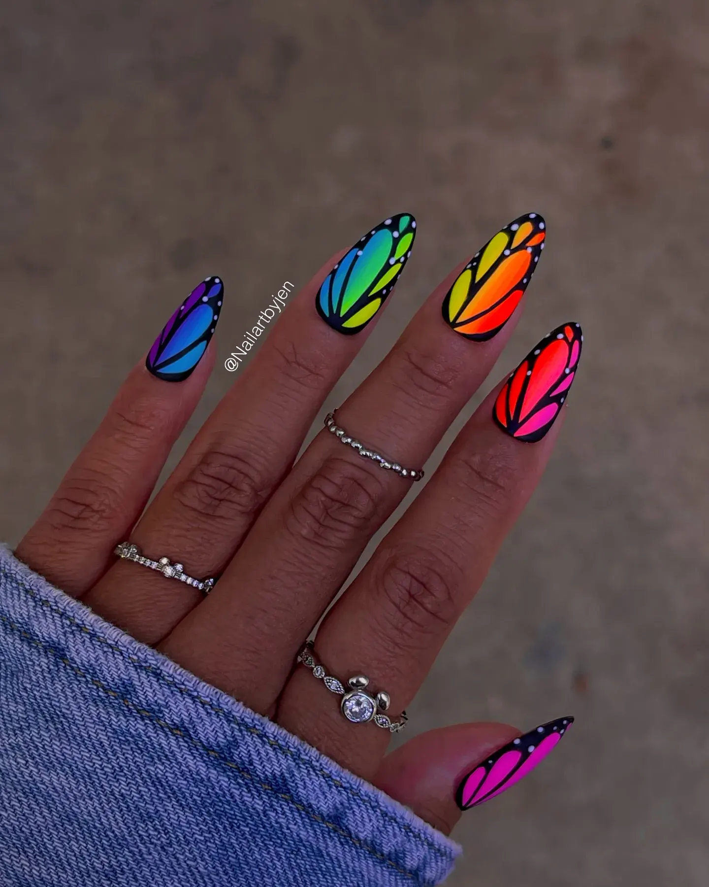 Rainbow neon wings outlined in black create the most magical butterfly-inspired manicure ever — bold yet beautifully detailed.
