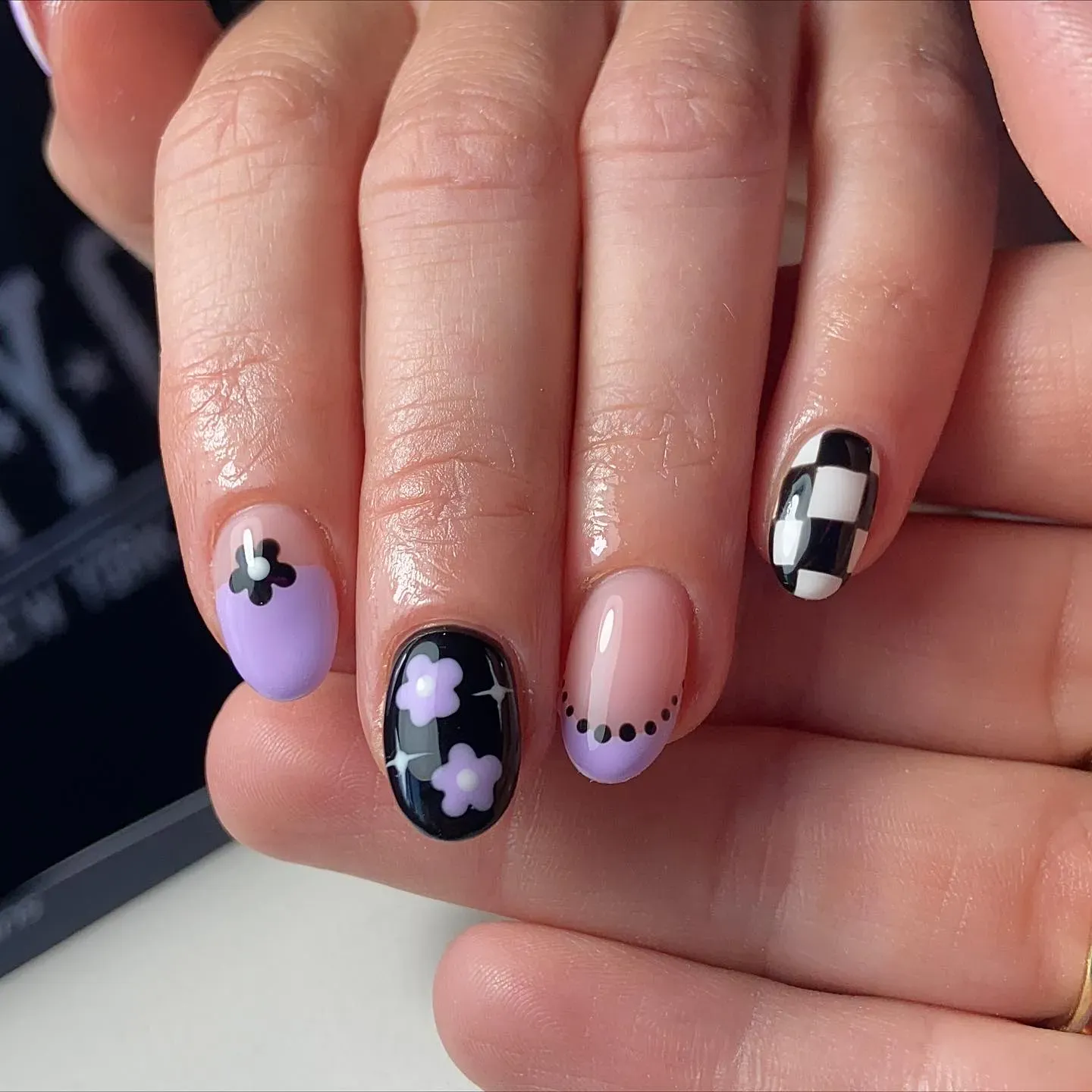 This look combines soft lavender with black-and-white checkers and dainty flowers for plum nails with design that’s trendy but still simple enough for everyday wear.