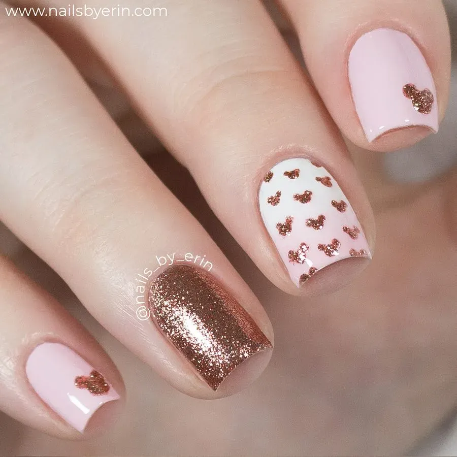 Simple pink and white nails with tiny glitter Mickeys β cute, minimal, and full of magic.