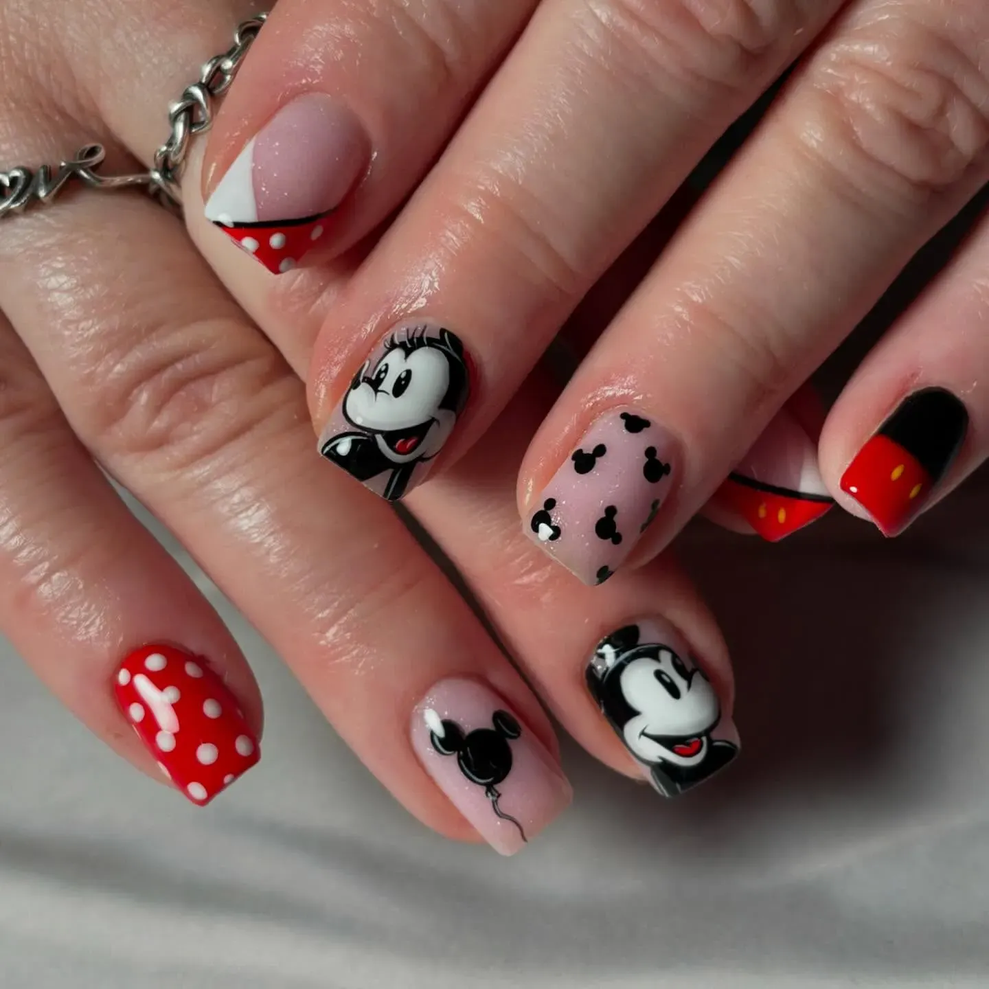 Nothing says Disney quite like the OG duo! These nails feature polka dots, Mickey balloons, and sweet cartoon portraits — total nostalgia overload.