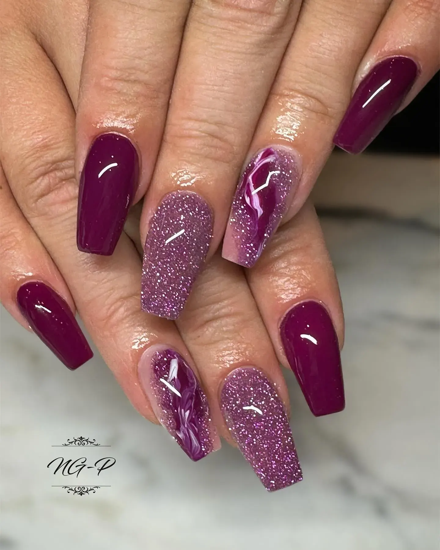 These dark purple fall nails have a cosmic shimmer that looks like a starry sky. The black undertone keeps them chic, while the glittery purple adds just the right amount of drama.