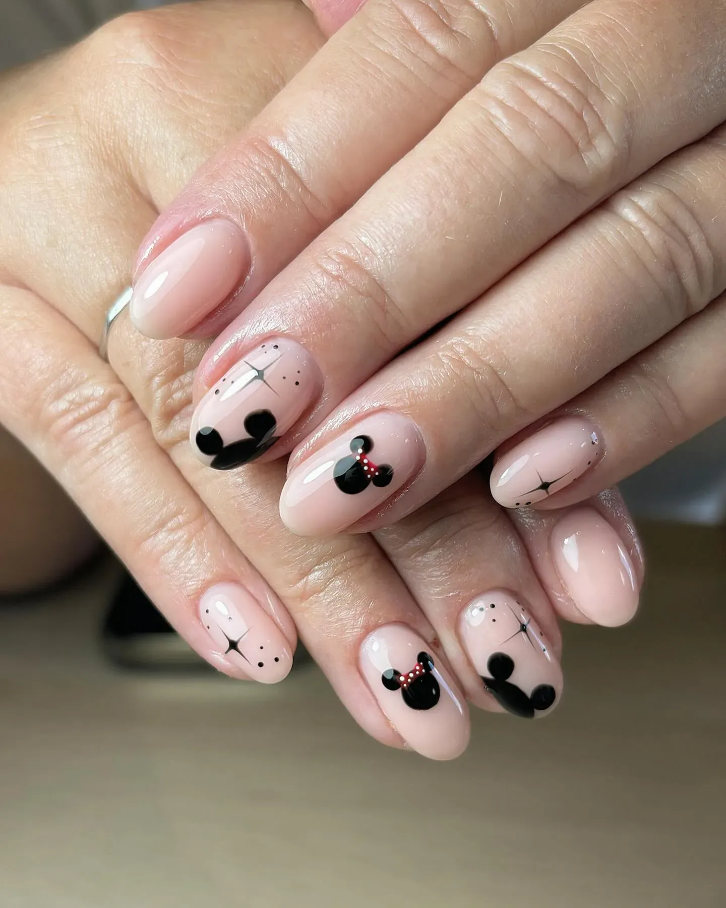 Timeless nude nails with sweet Minnie and Mickey silhouettes. Subtle enough for every outfit, magical enough for every photo.