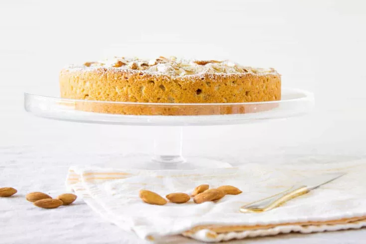 This peach almond cake recipe reminds me of Grandma’s warm embrace and infectious smile. It’s the peach cake you lounge on the sofa with as the afternoon sun tickles your cheek and spreads warmth all the way down to your toes.