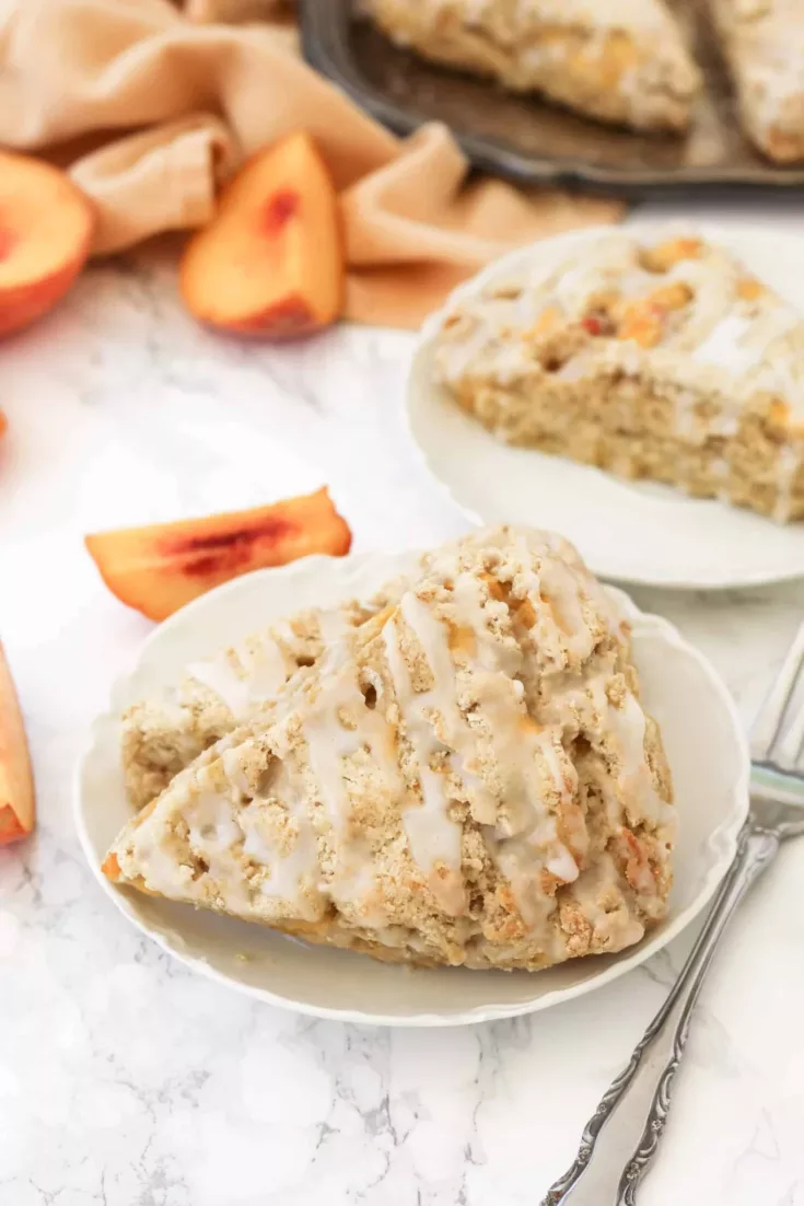 These fluffy gluten-free Peach Scones are filled with pops of sweet peaches throughout and topped with a light glaze. They’re great for an end of Summer breakfast or brunch!