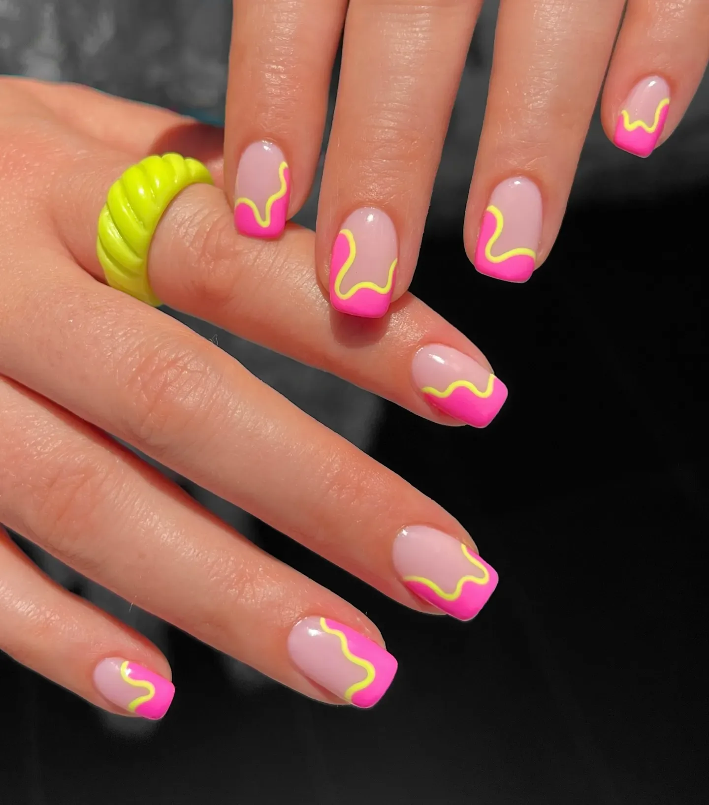 Pink tips outlined with neon yellow squiggles — a playful upgrade for anyone who loves a fun twist on the classic French mani.