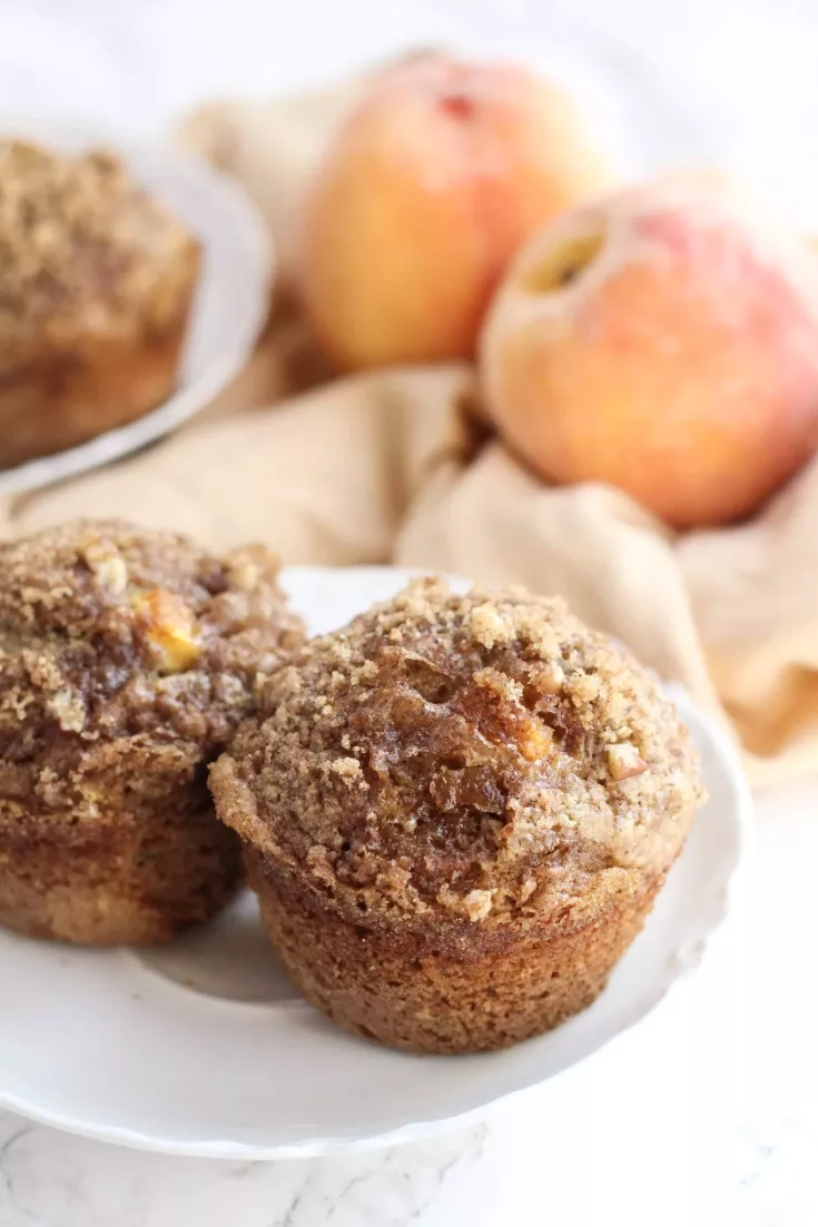 Filled with diced fresh peaches, chopped pecans, and topped with a brown sugar cinnamon topping, these spiced peach muffins are a healthier breakfast with a whole lot of flavor!