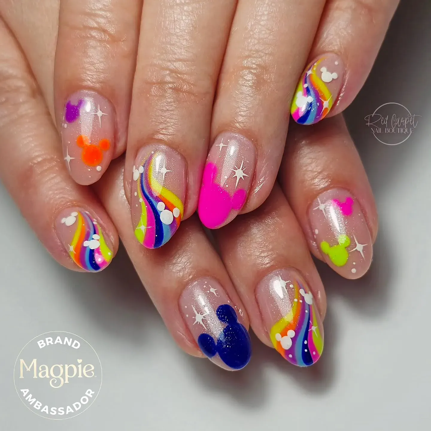 Bring some dopamine-boosting color to your Disney trip with these vibrant neon Mickey heads and glittery rainbow stripes.