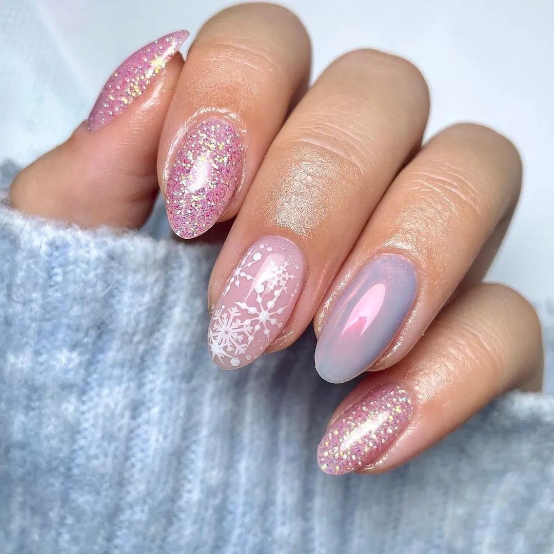 Shimmering glitter, snowflake details, and a touch of icy chrome make this set sparkle like fresh snow. These trendy winter nails are a perfect mix of frosty elegance and pink holiday magic.