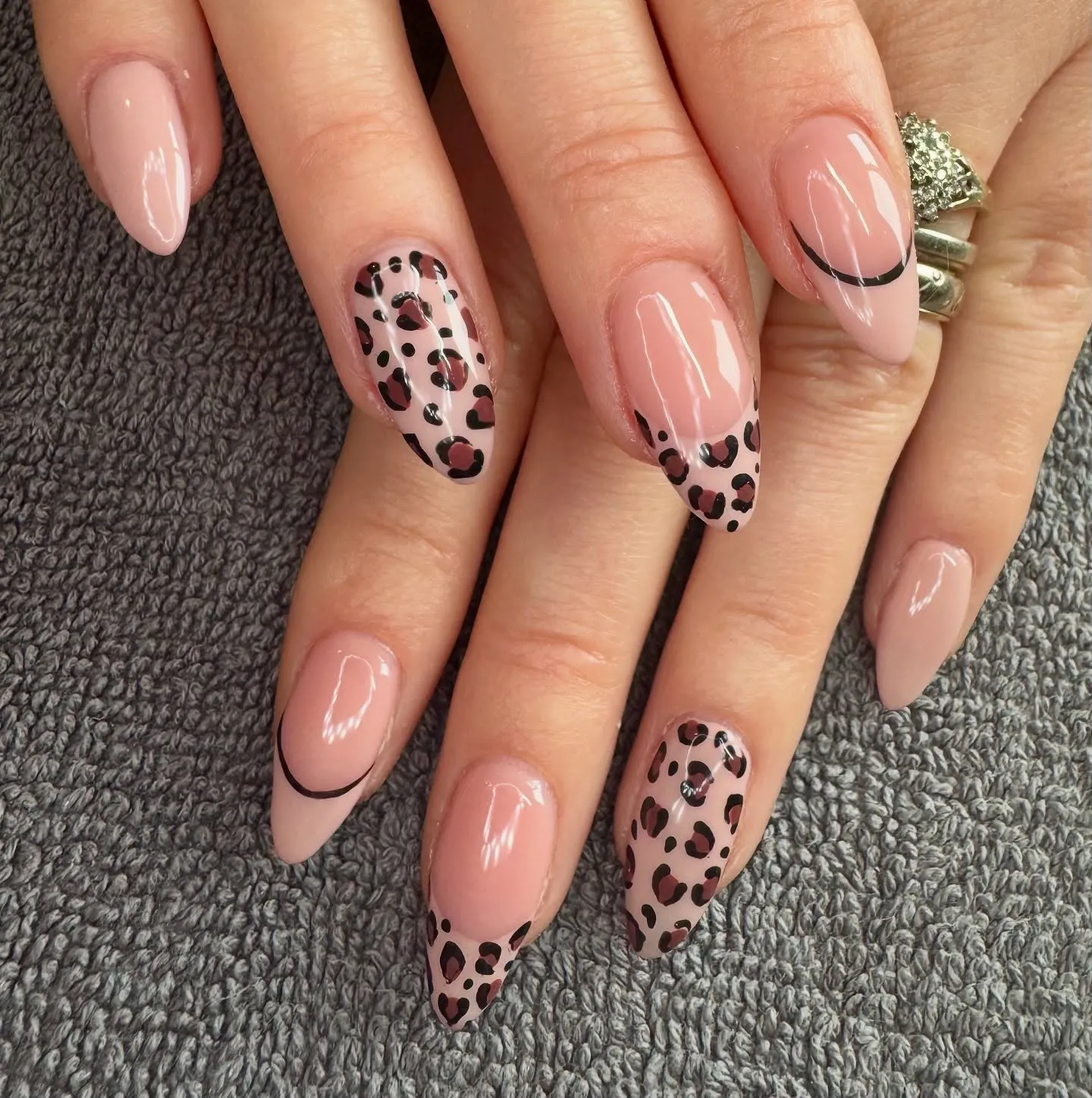 This sleek nude set from @sophiesbeautyatsix puts a modern spin on leopard print with alternating designs that feel super polished. The look pairs crisp black-outlined French tips, full print accents, and scattered spots along the edges — all on a glossy nude base that keeps things chic and understated. A fab choice if you're after Leopard Print Nails that feel wearable but still make a statement.