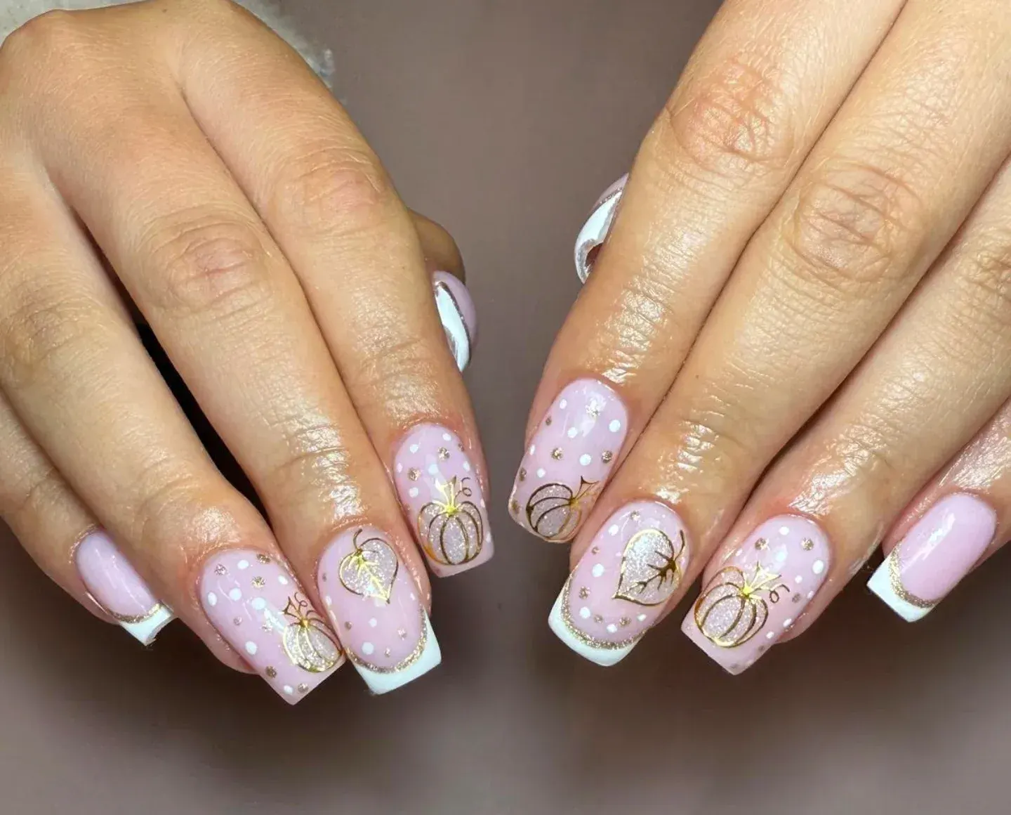 Soft pink French tips meet dainty white dots and gold pumpkin outlines in this dreamy fall manicure thatβs equal parts classy and seasonal. ππ