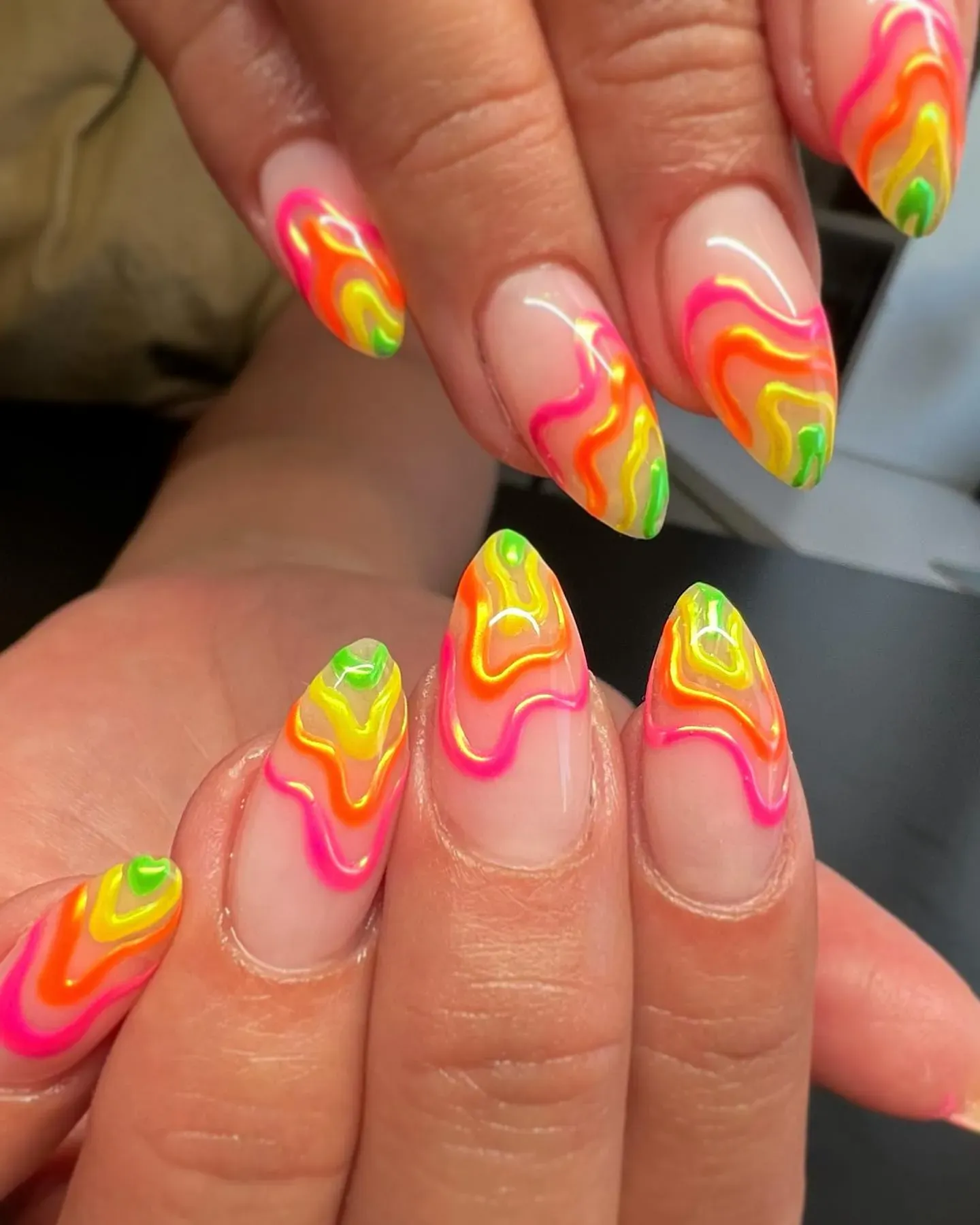Glossy, 3D neon swirls in pink, orange, yellow, and green — this one’s giving retro summer rave vibes in the best way.