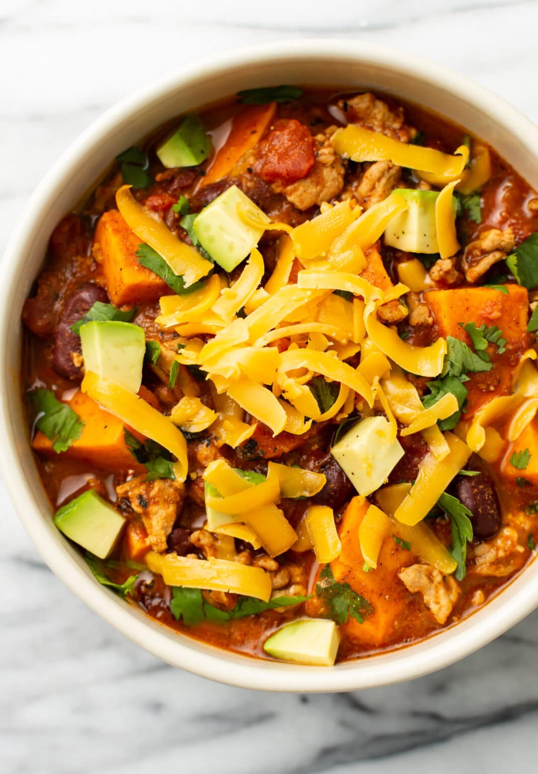 Spice up your January meal plan with this hearty chili. Ground turkey, chunks of sweet potato, and warming spices make it a hit for family dinners.