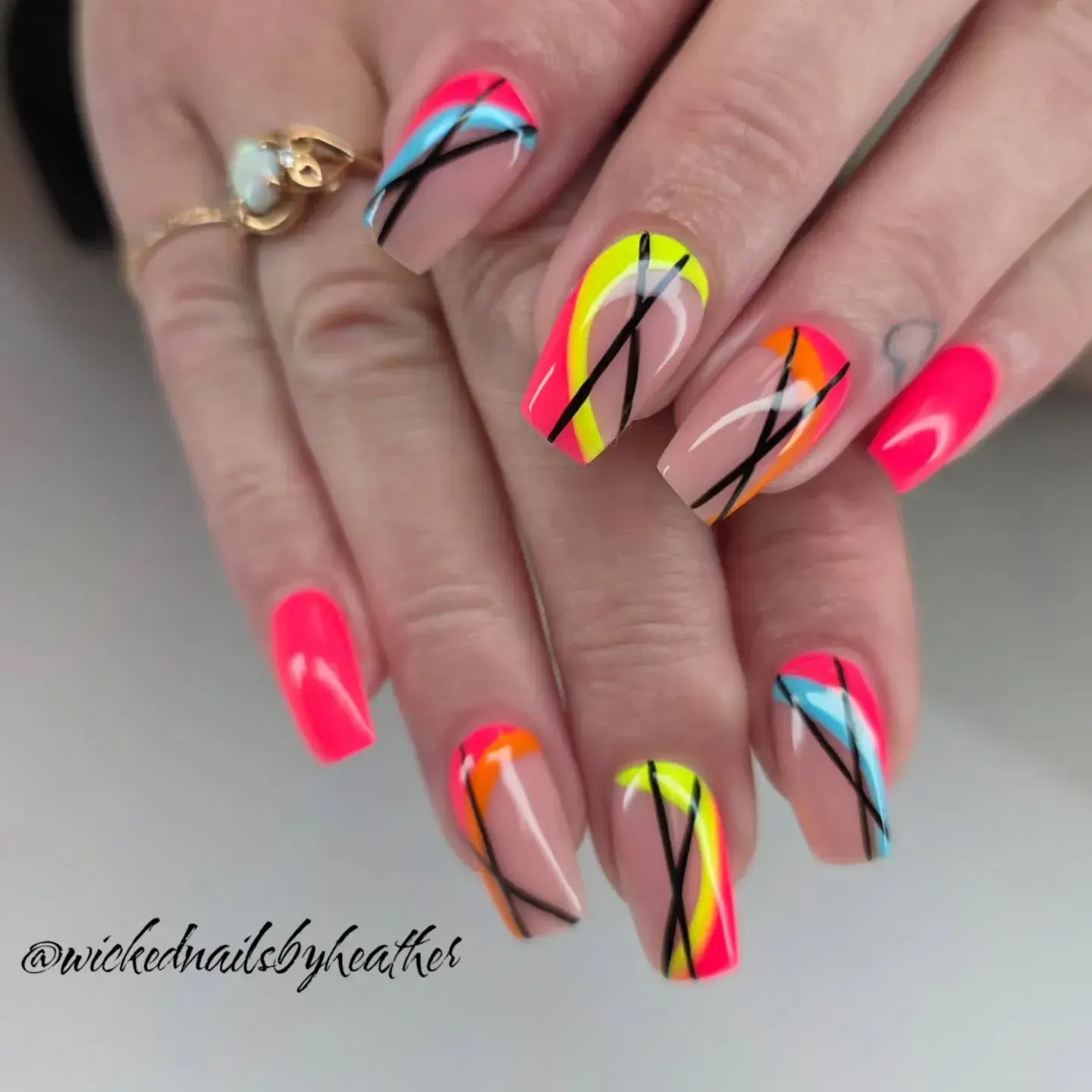 Vibrant pink, yellow, and blue swirls with sharp black lines create an instant statement look. It’s modern, artsy, and full of energy!